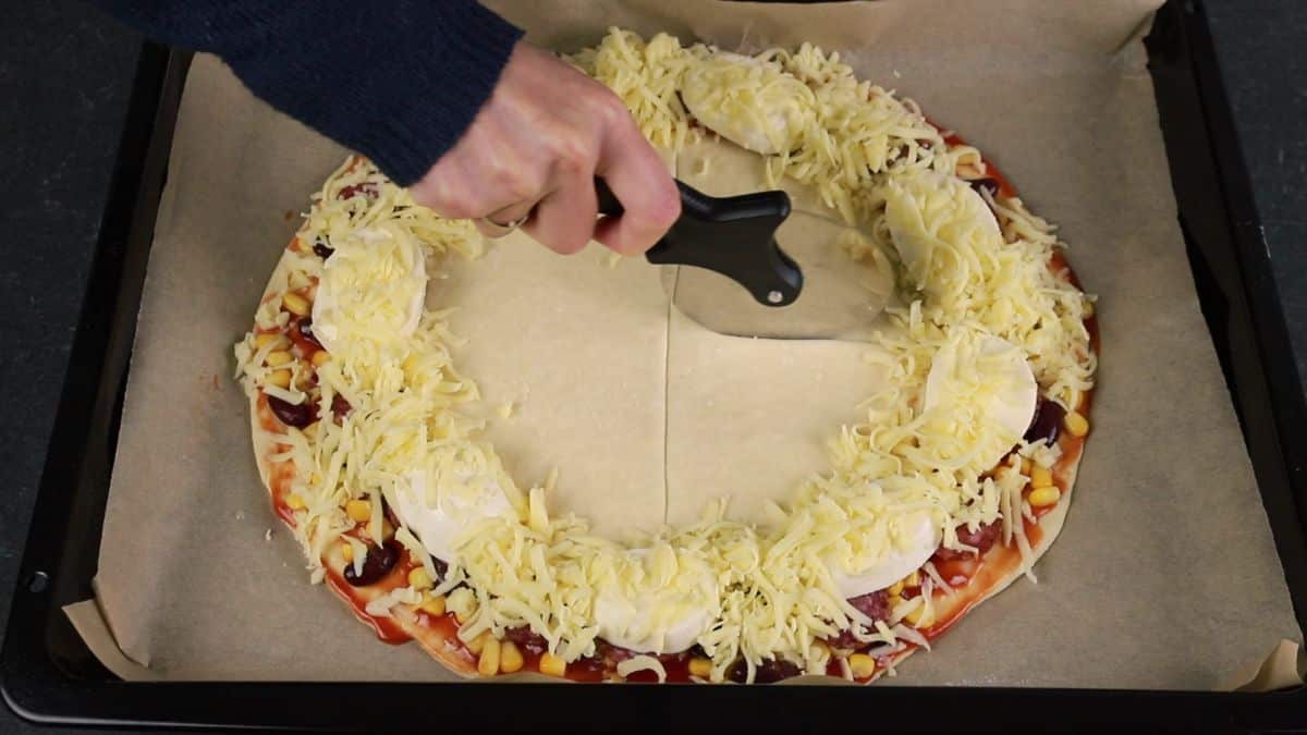 pizza cutter on dough