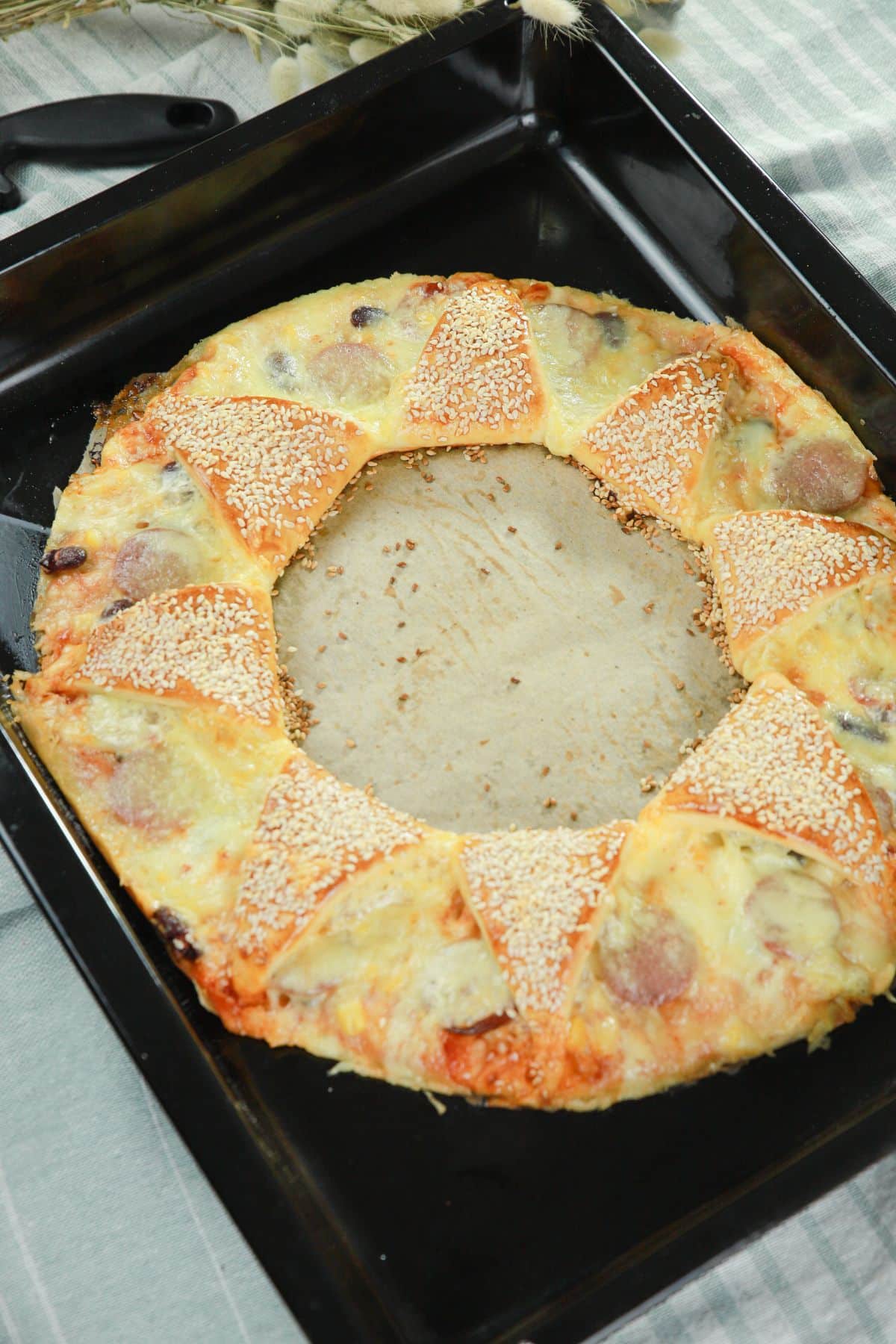 cooked pizza ring on baking sheet