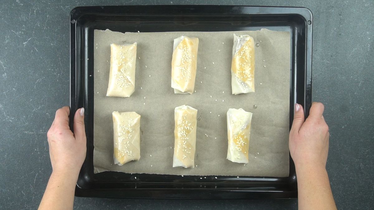 unbaked eggrolls on baking sheet