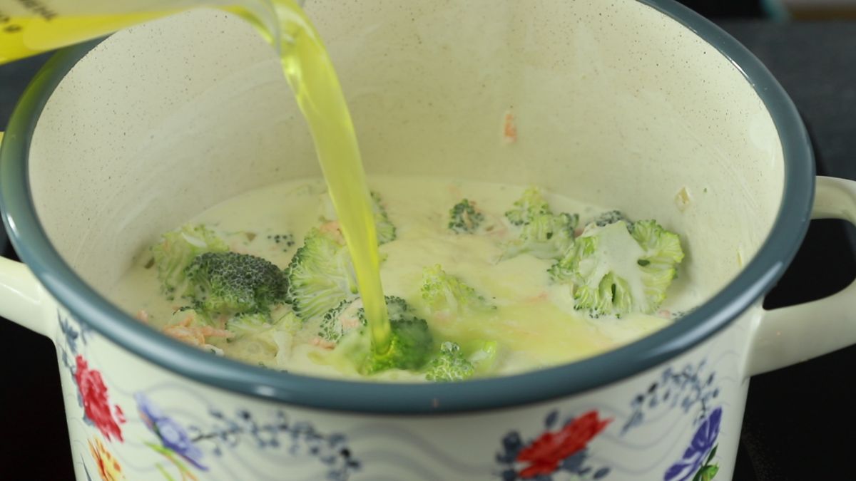 vegetable broth being poured into broccoli soup