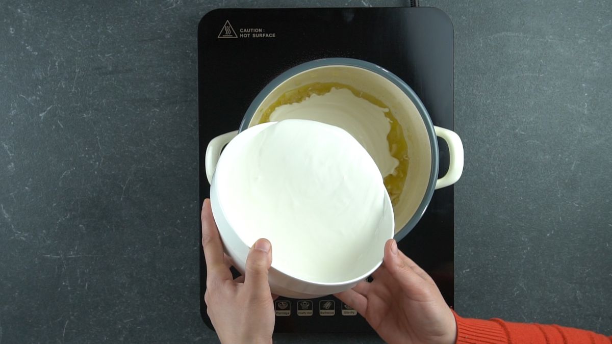 cream being poured into stockpot on hot plate