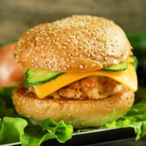 sesame seed bun cheese and pickle on chicken burger