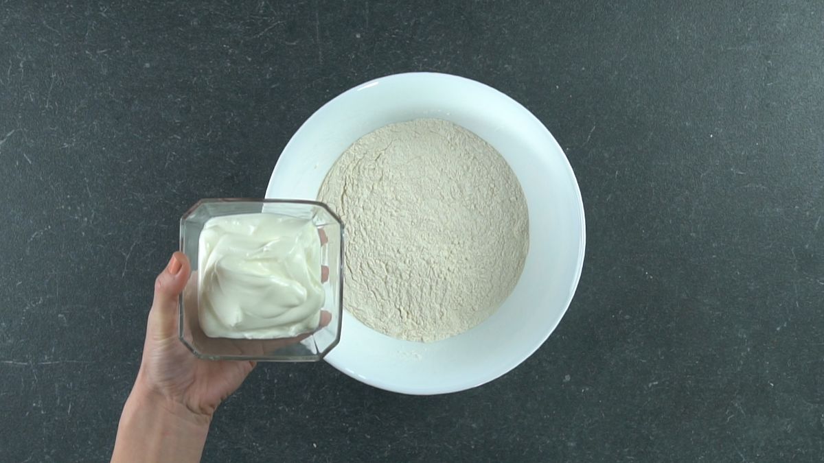yogurt being added to flour for donut