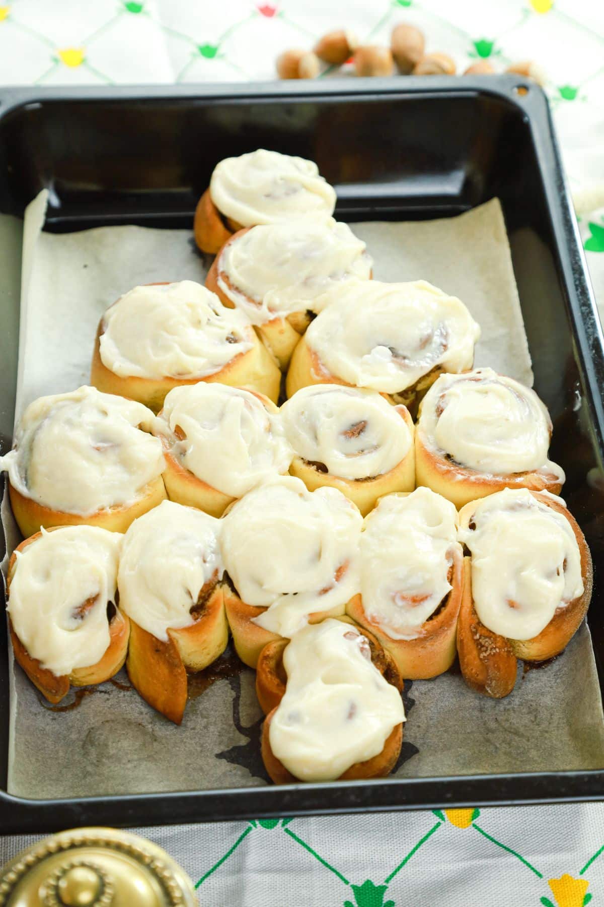 baking sheet of cinnamon rolls with cream cheese icing