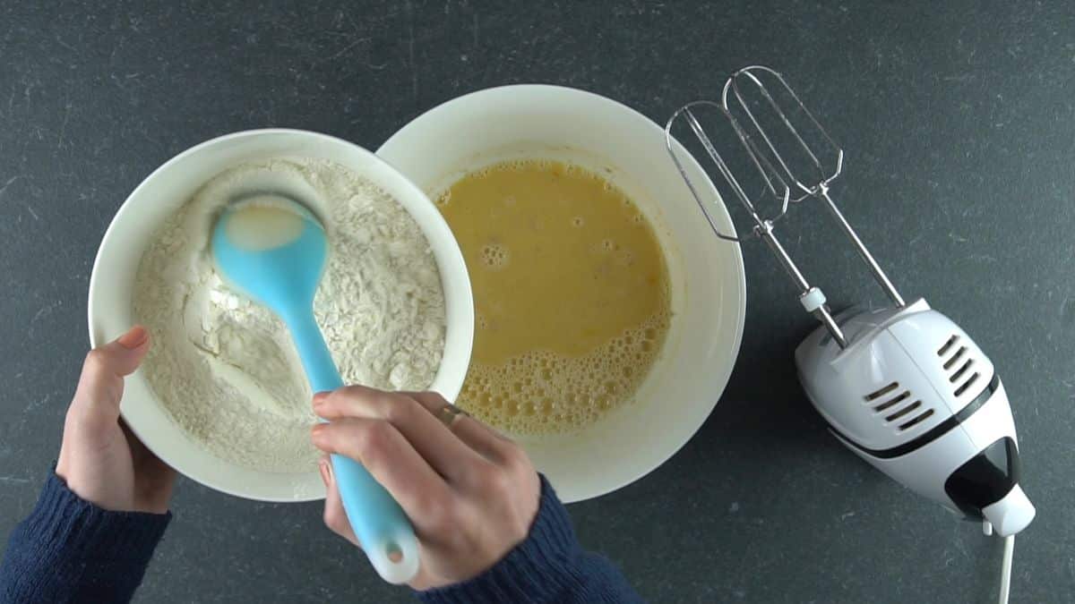 flour being added to yeast roll dough