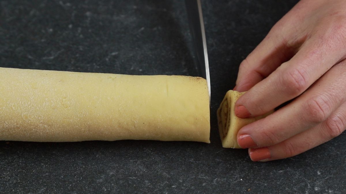 knife cutting cinnamon rolls