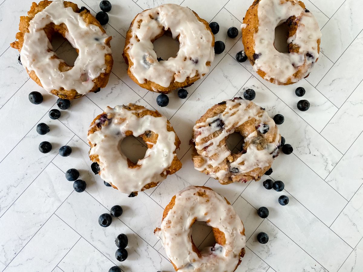 blueberry donuts with glaze on white table