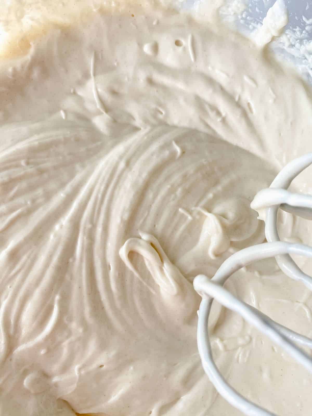 whisk above bowl of white cake release mixture