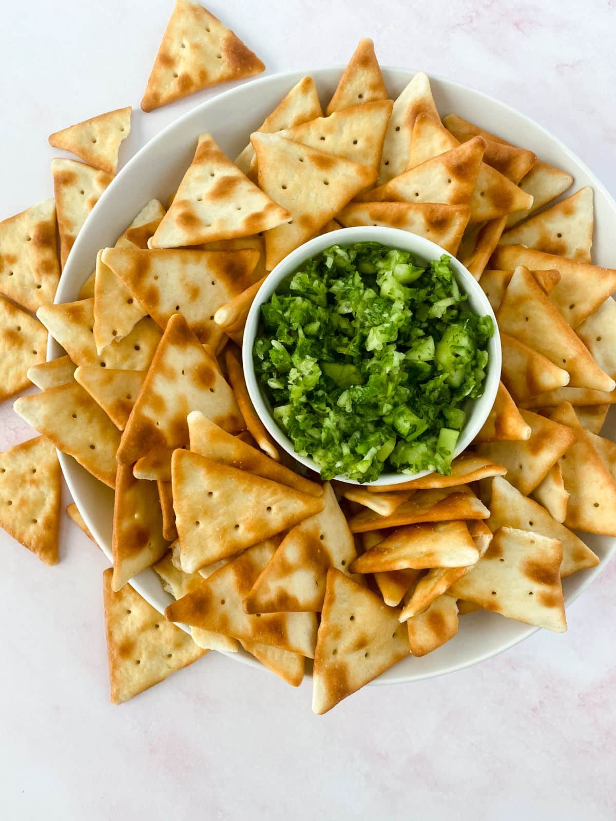 bowl of chips with relish in center of platter