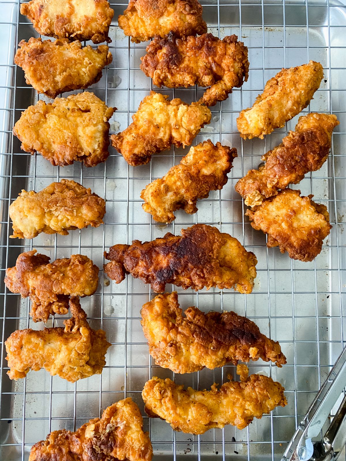 cooked buffalo chicken tenders on wire rack