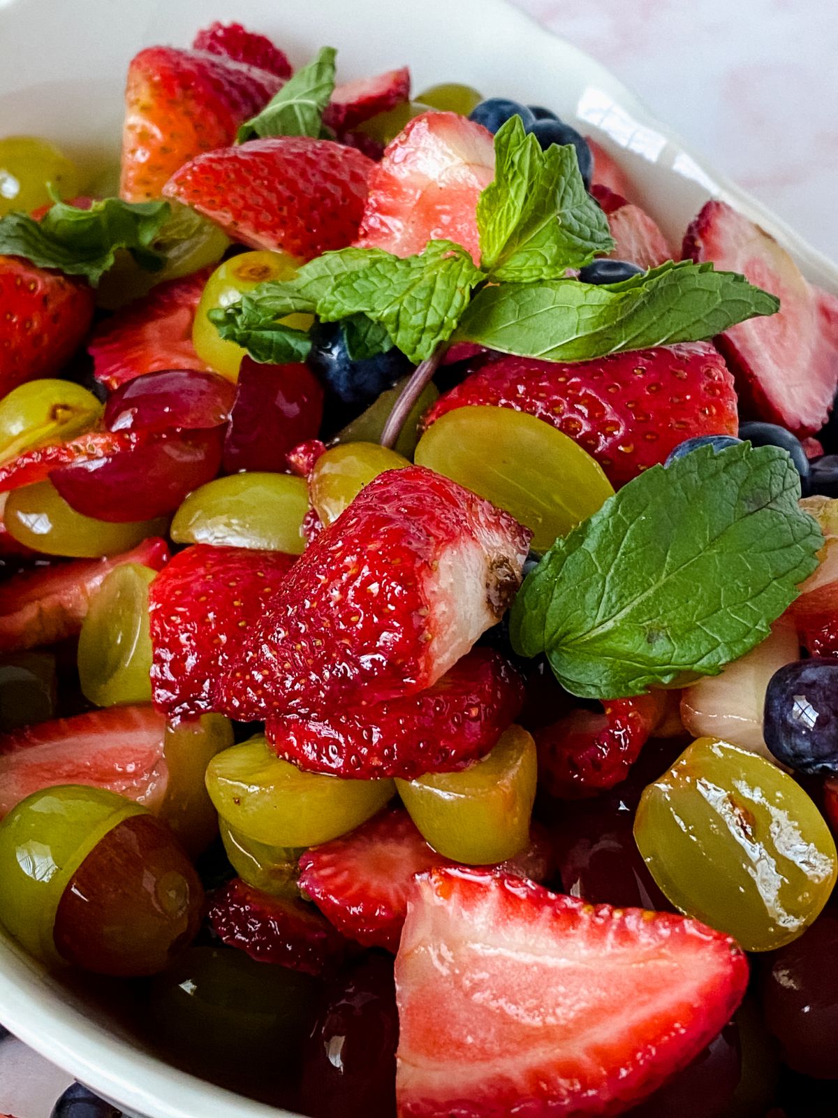 bowl of fruit salad with fresh mint on top