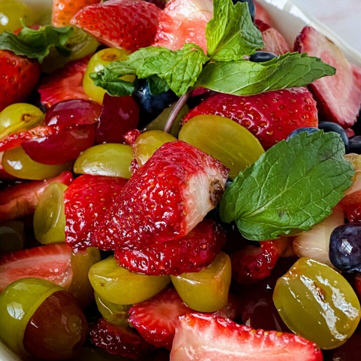 bowl of fruit salad with fresh mint on top