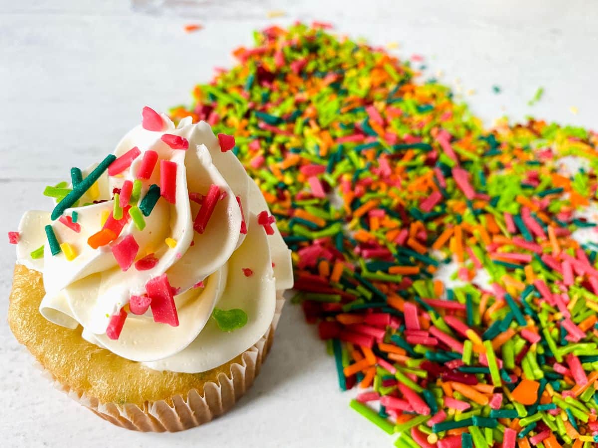 cupcake on table by pile of sprinkles