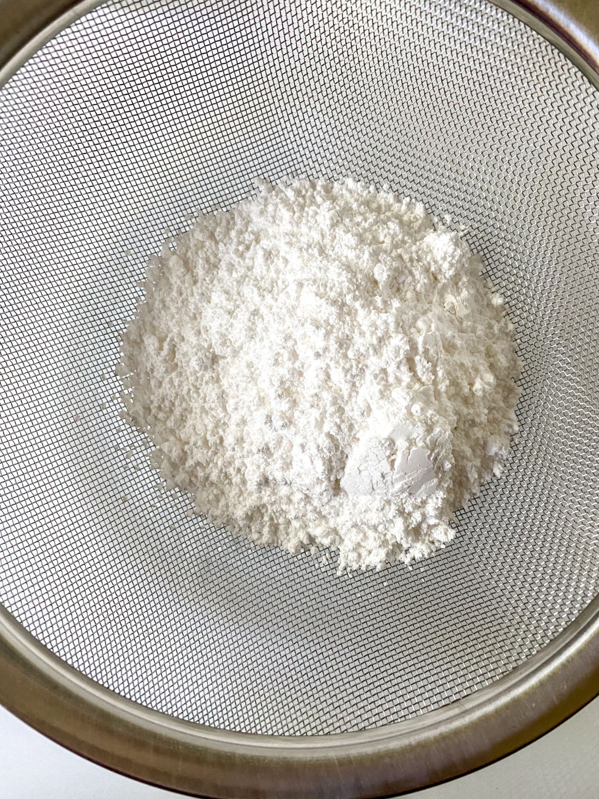 glass bowl of powdered sugar