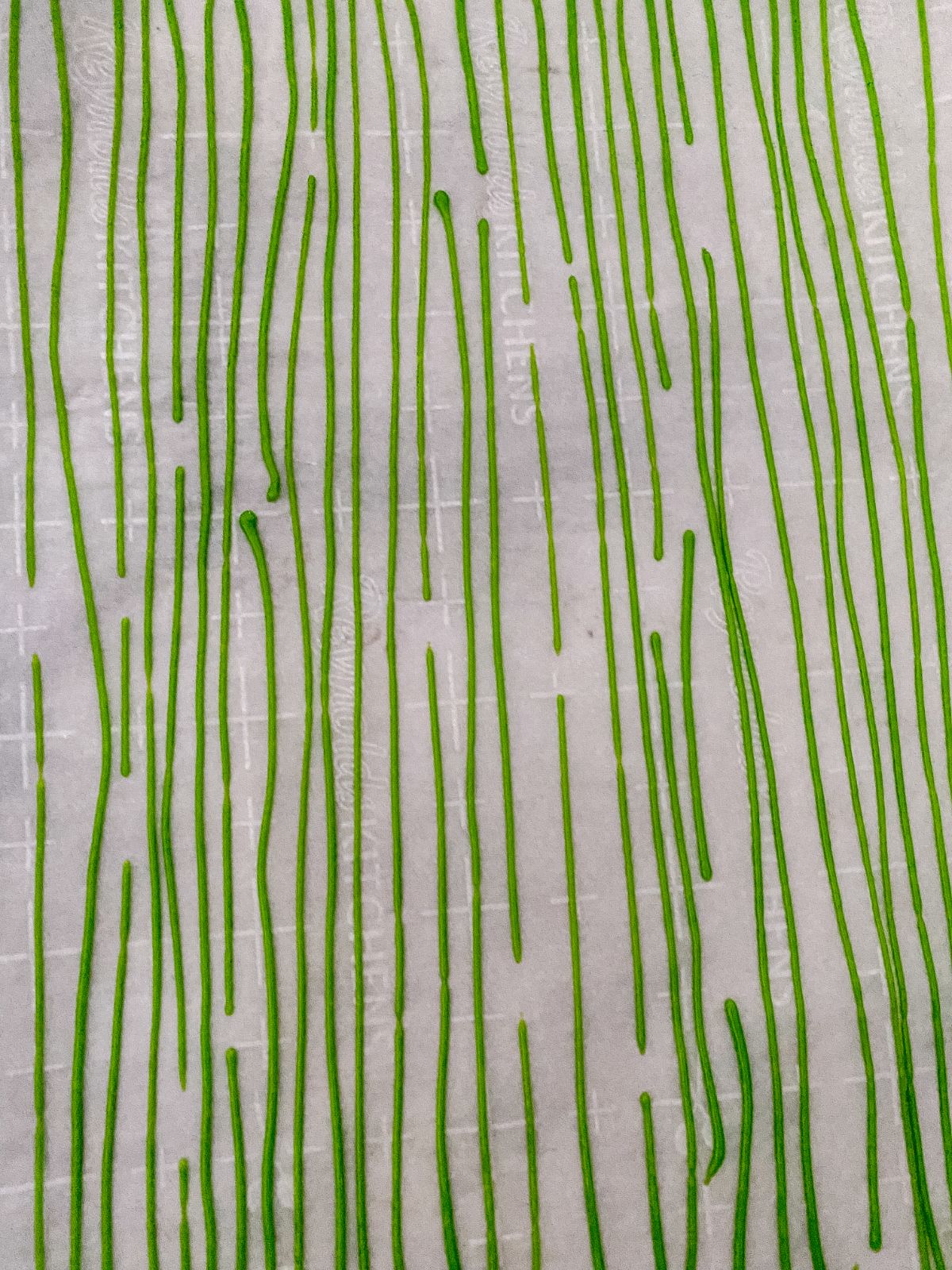 strips of green sprinkles on parchment paper