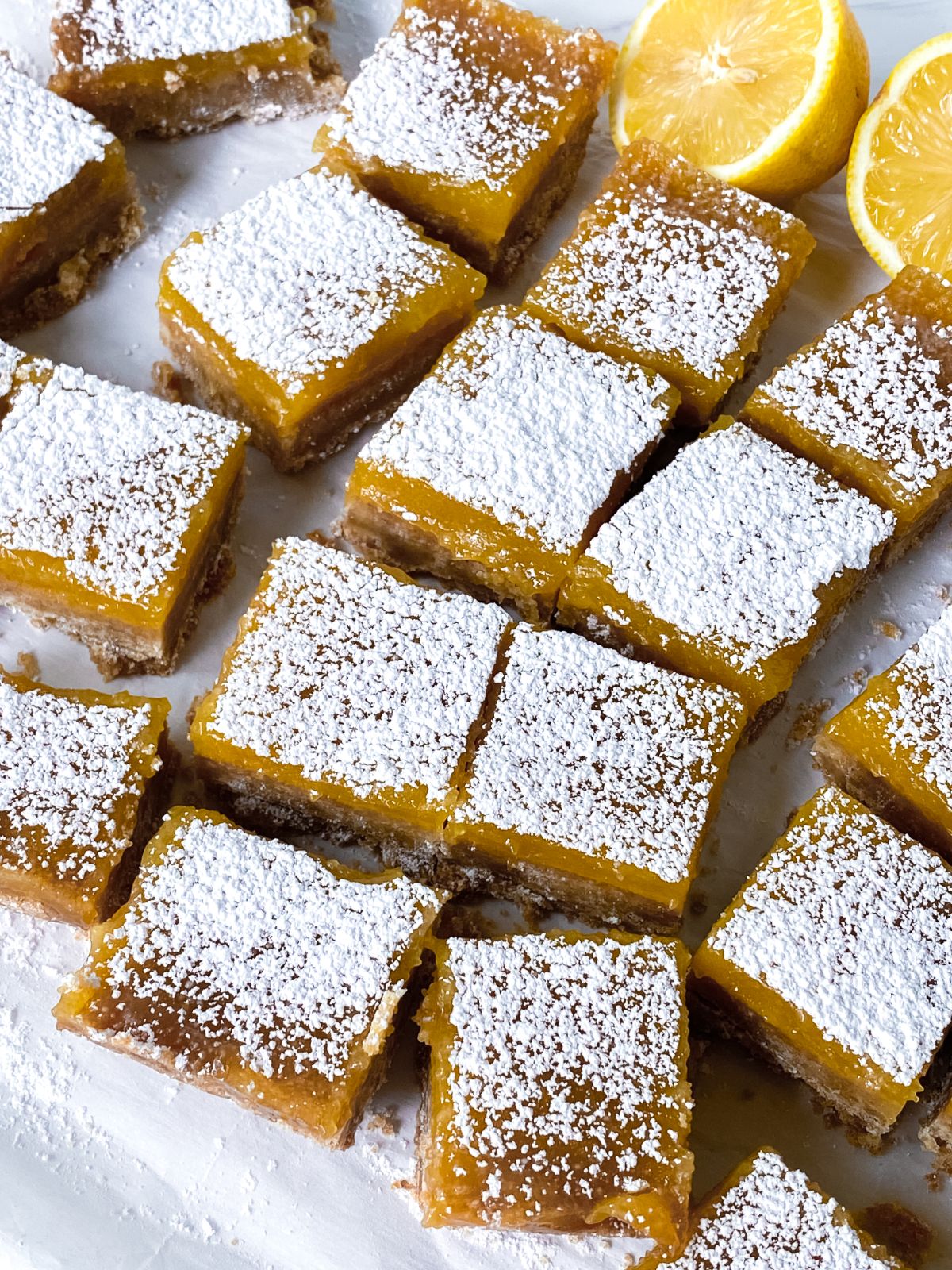 square of lemon drop bars topped with powdered sugar