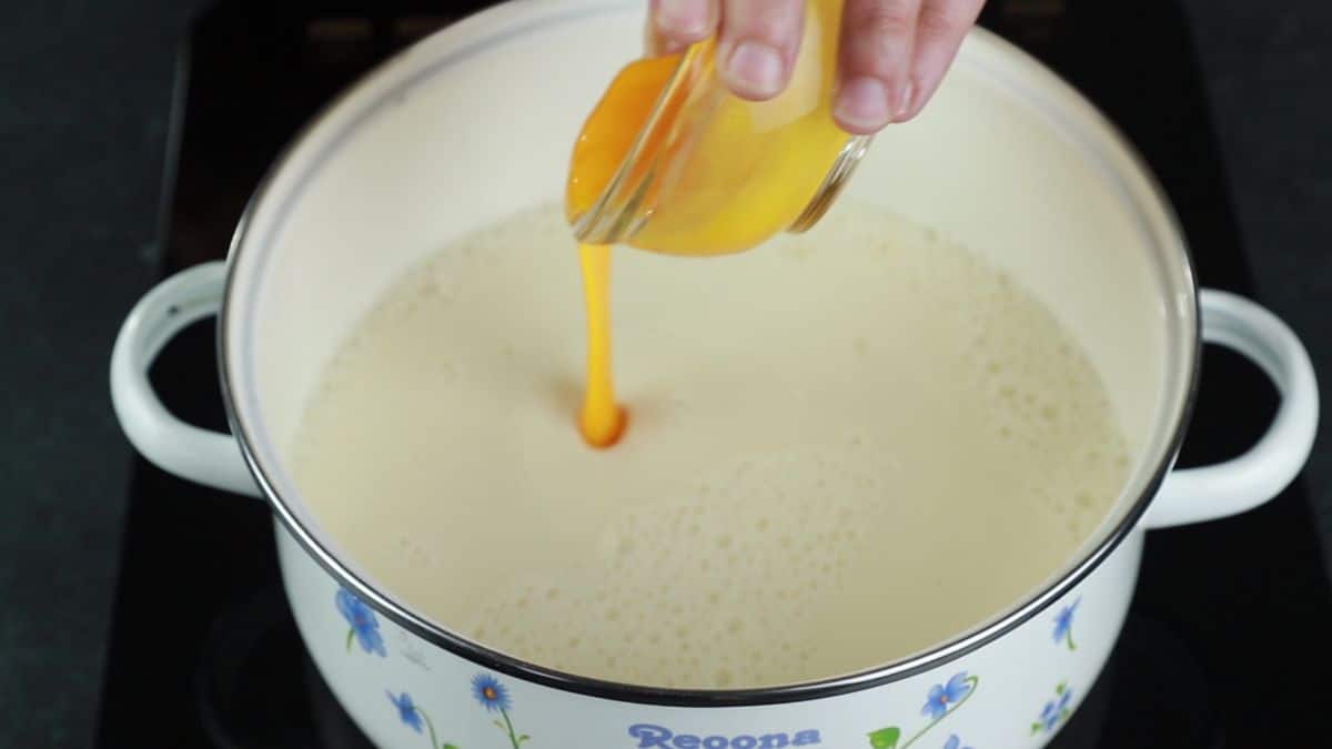 pouring egg yolk into Bavarian cream base