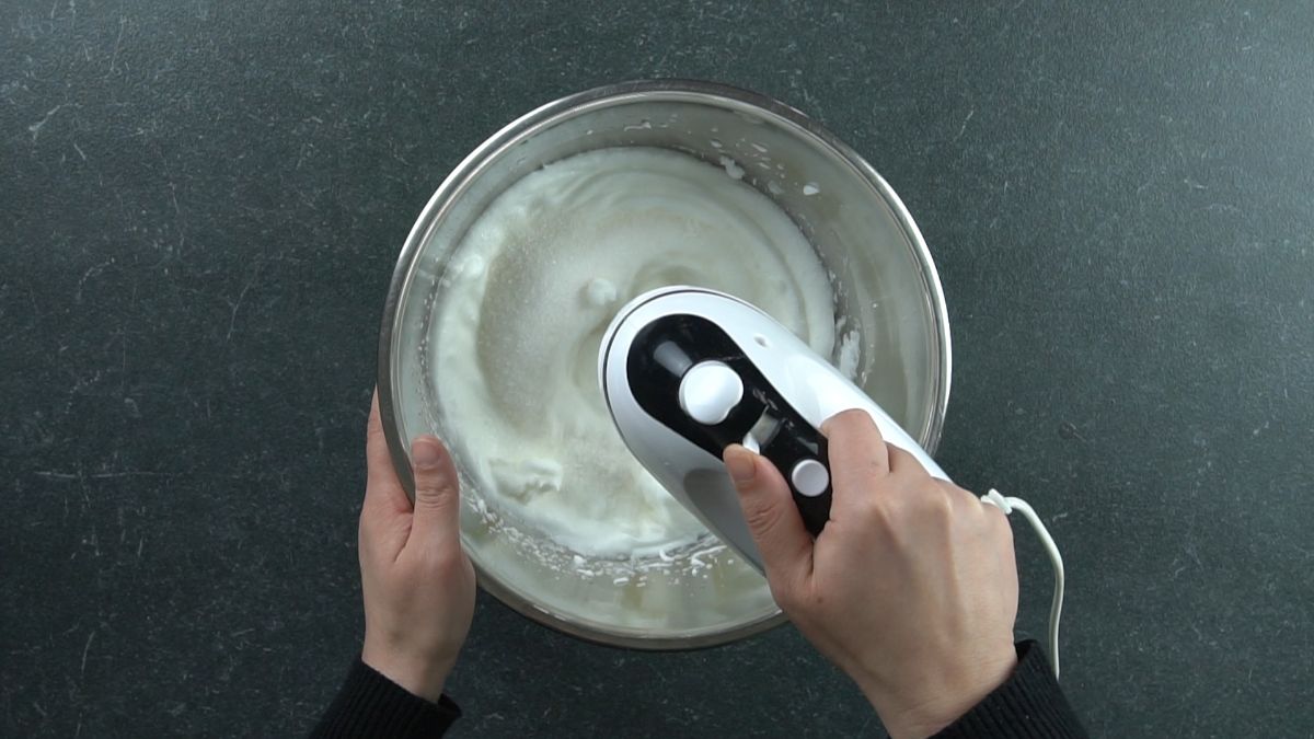 hand mixer in bowl making meringue