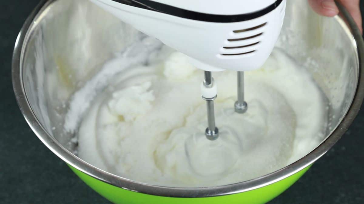 hand mixer in bowl of egg whites