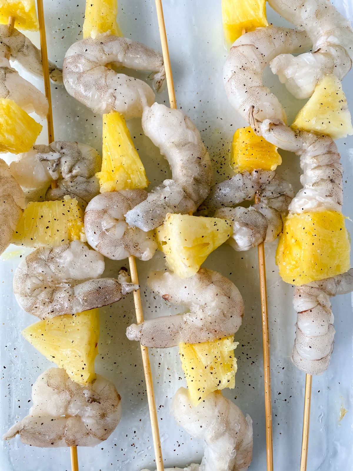 shrimp and pineapple on wooden skewers