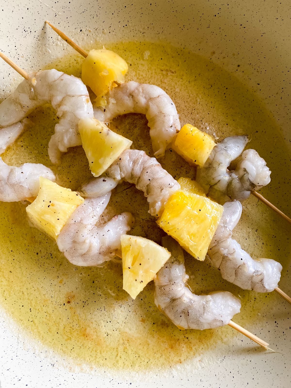 shrimp and pineapple skewers in skillet