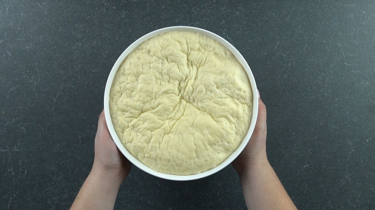 white bowl of risen potato bread
