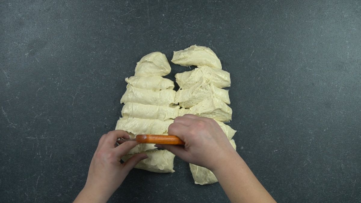 bread dough being cut into smaller pieces
