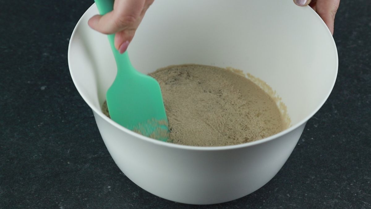blue spoon stirring yeast and water together