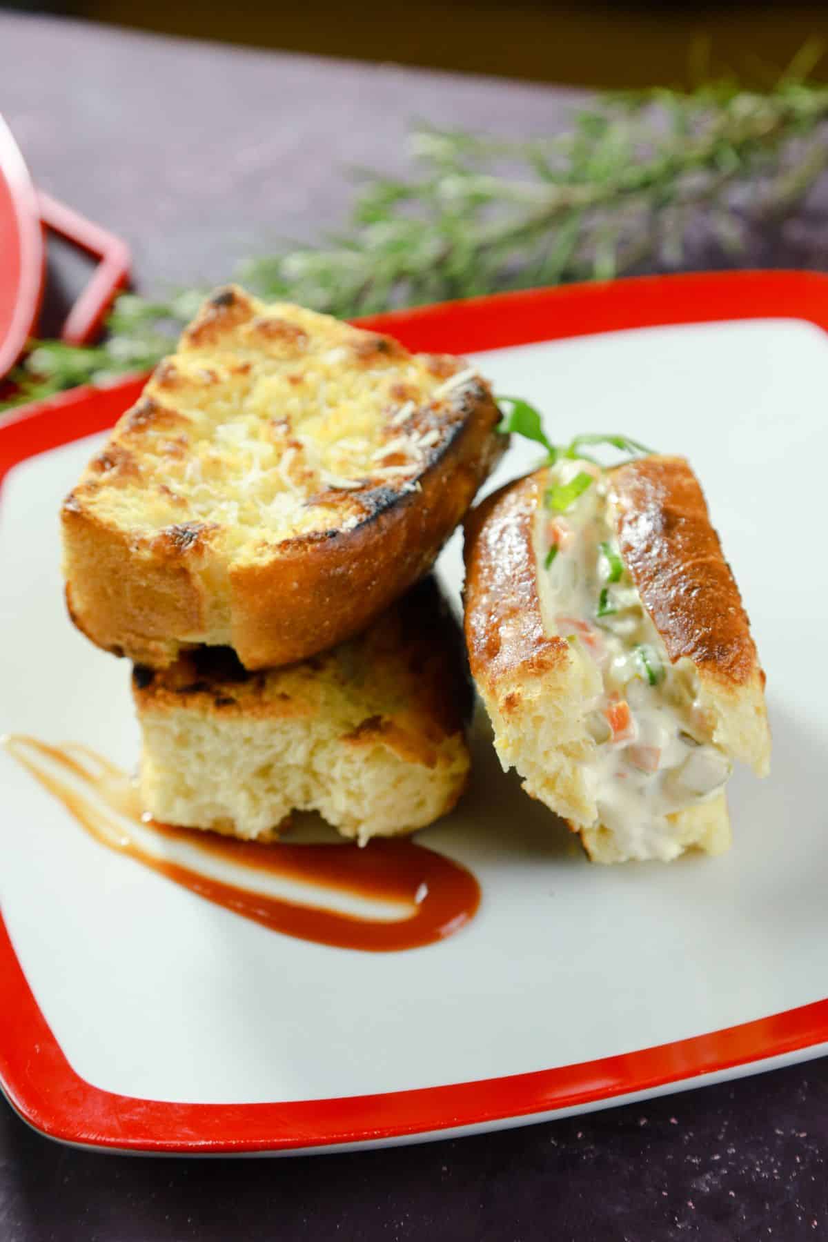 sliced potato bread rolls on white and red plate