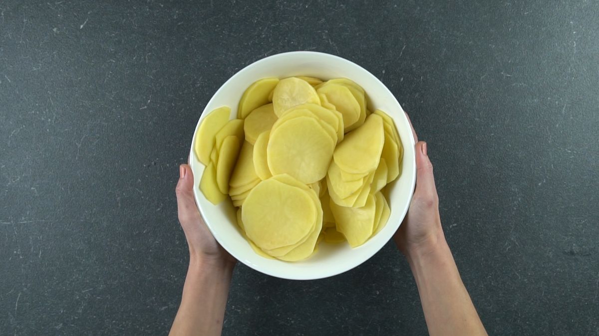 sliced potatoes in white bowl