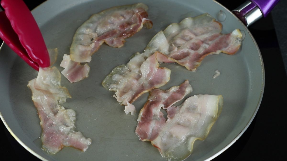 bacon being cooked on gray skillet