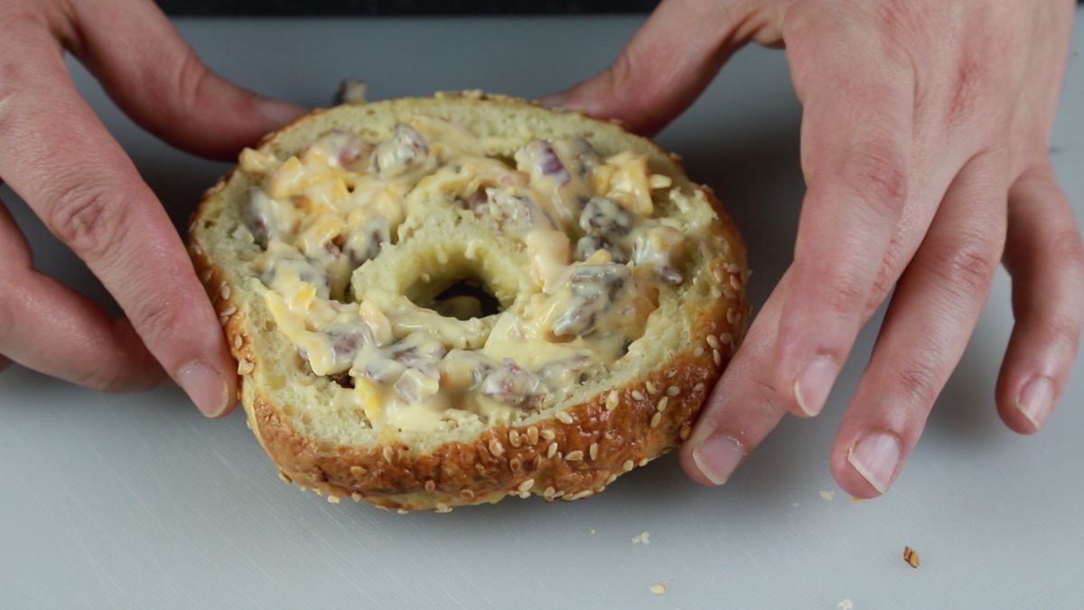 half a bagel stuffed with quiche filling