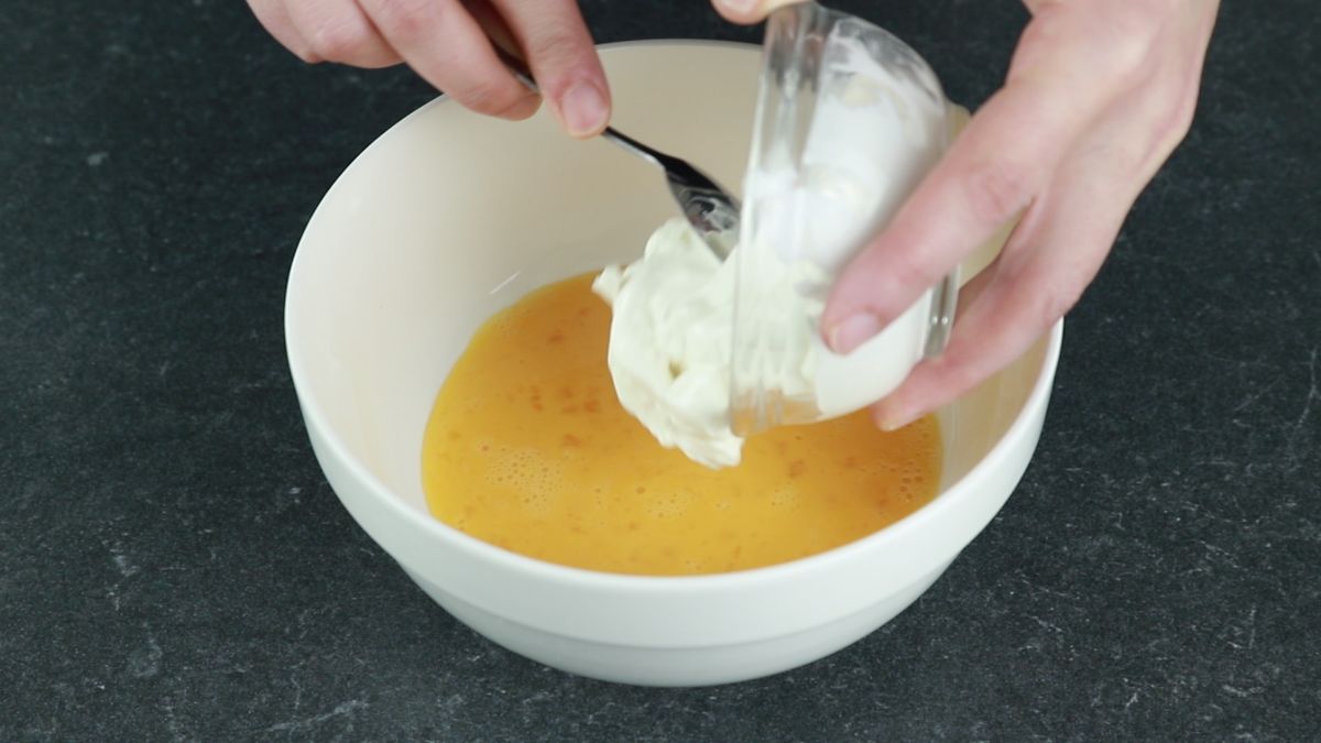 adding cream to eggs