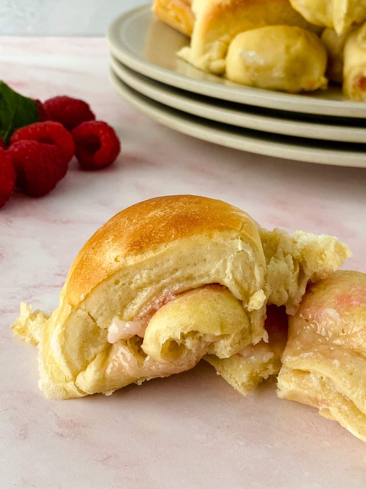 raspberry cream cheese crescent roll cut in half on table
