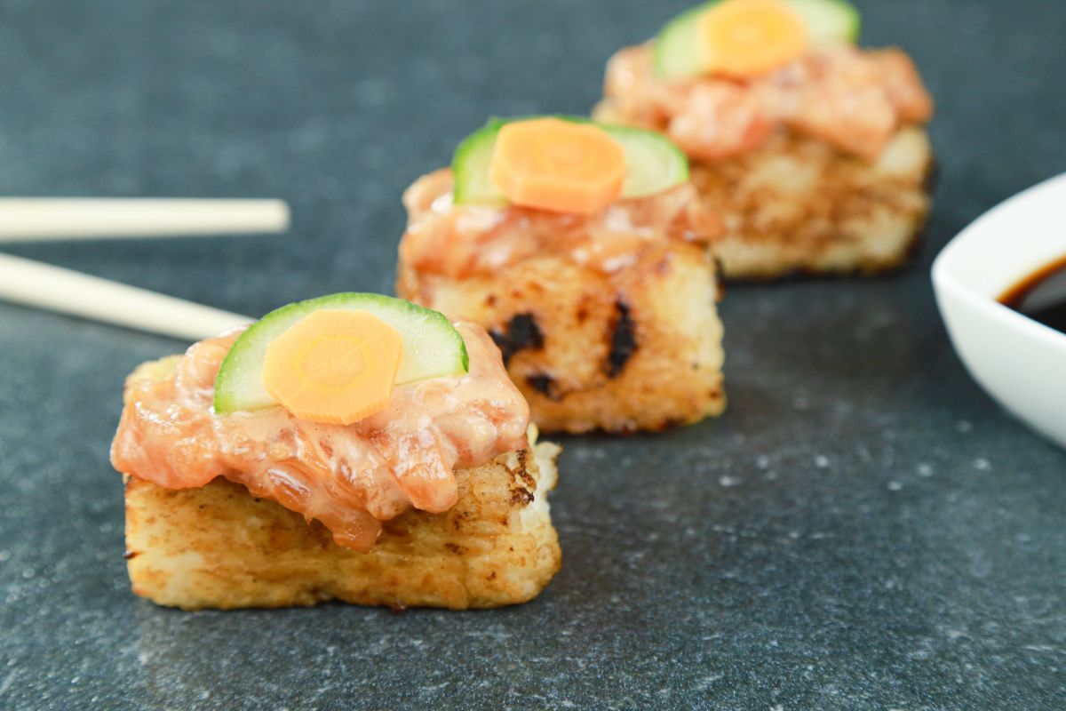 crispy rice with salmon topped with cucumber and carrot
