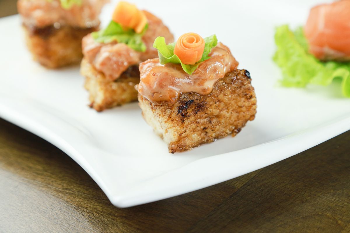crispy rice with salmon on white plate