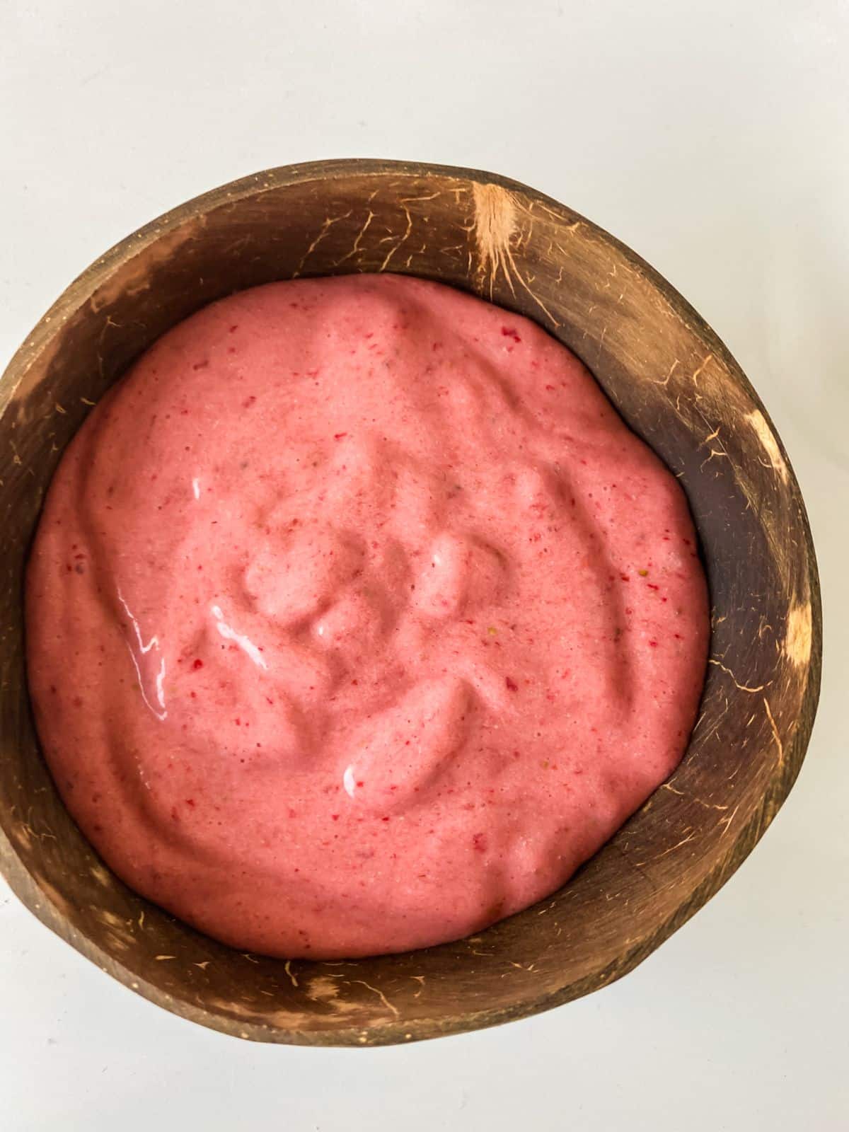 strawberry banana smoothie bowl in wood bowl