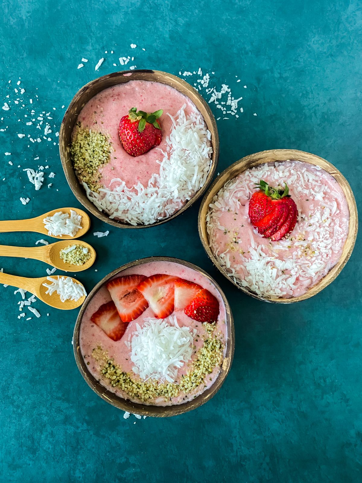 smoothie bowls topped with coconut and sliced strawberries