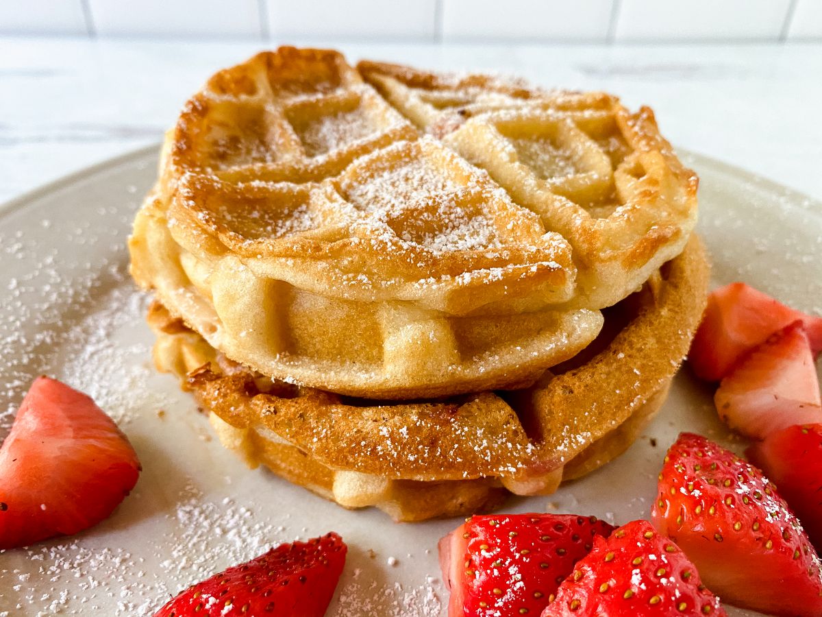 stack of waffles on plaet with strawberries