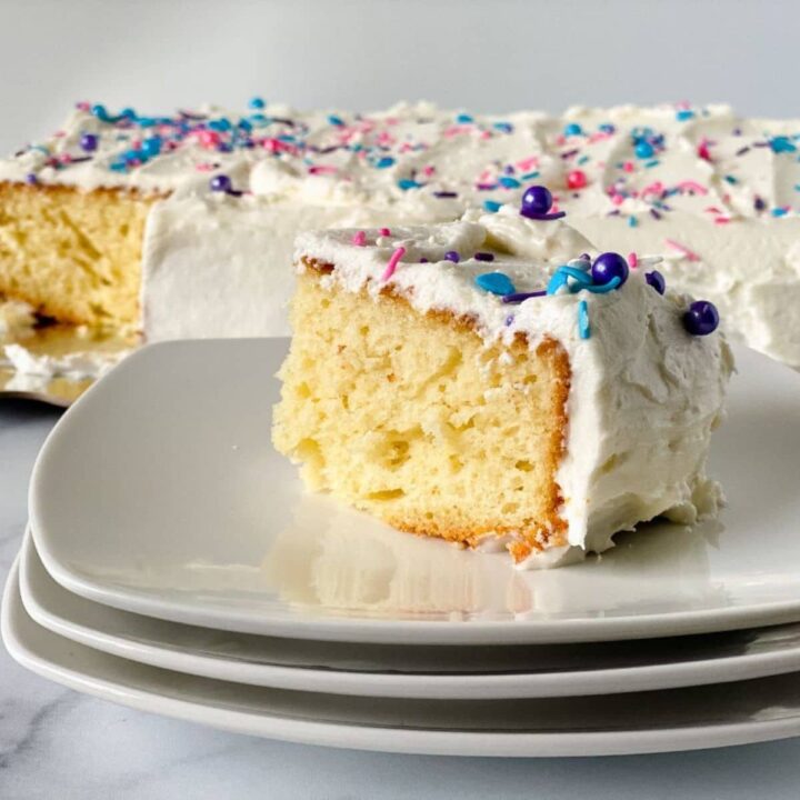 icing and sprinkles on top of slice of vanilla sheet cake