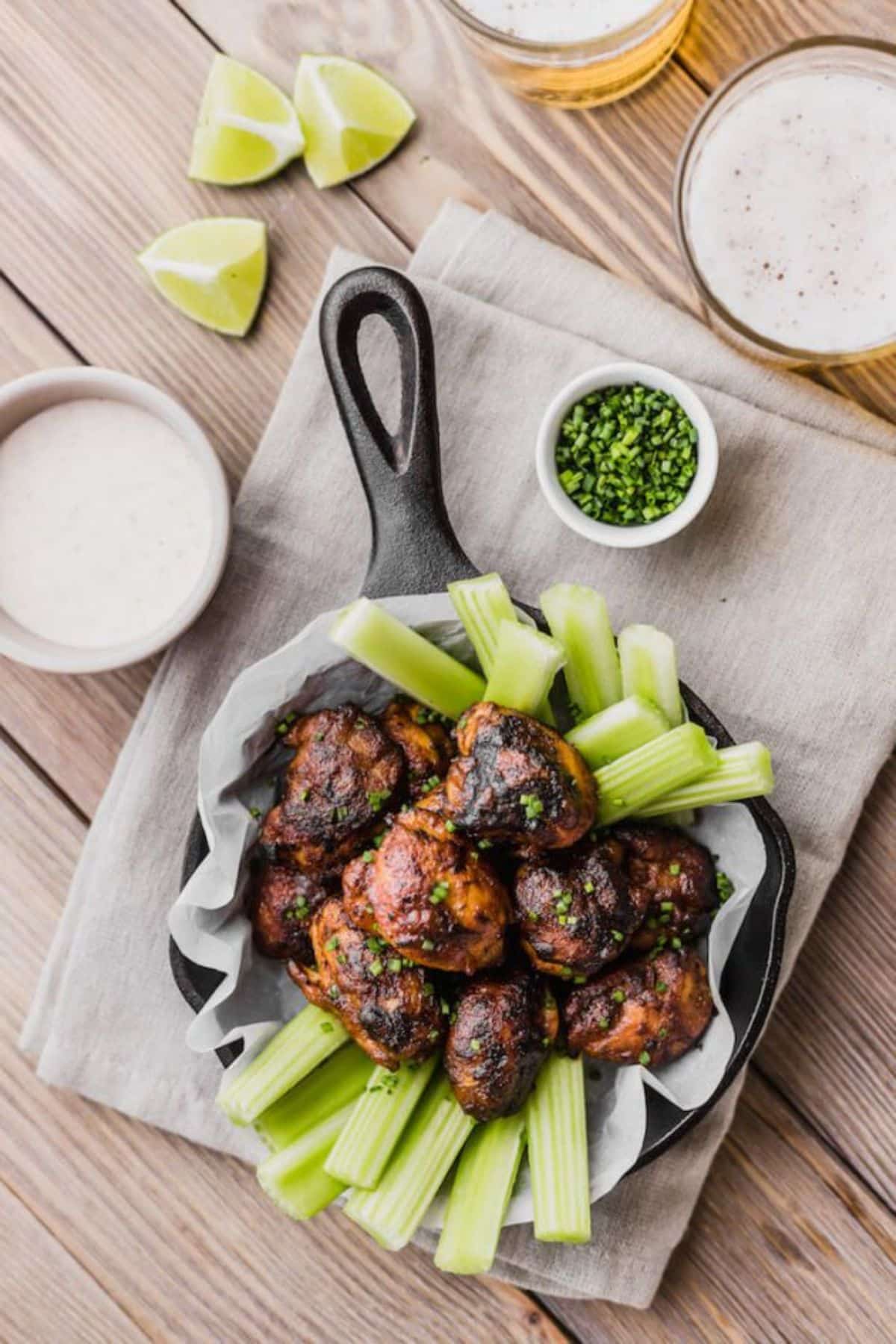 Boneless Spicy Wings with vegetables in a black pan.