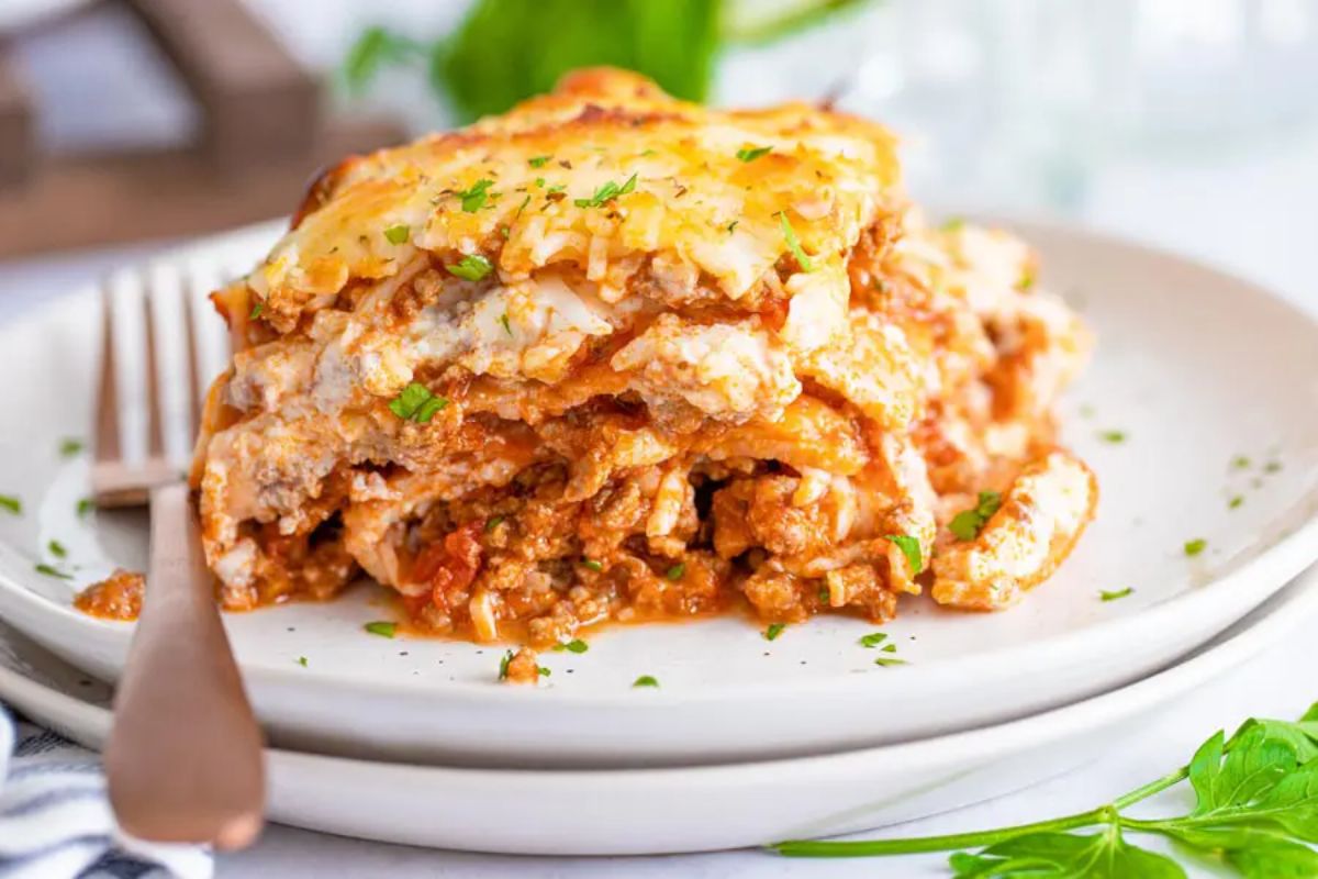 Low-Carb Keto Lasagna on a white plate with a fork.