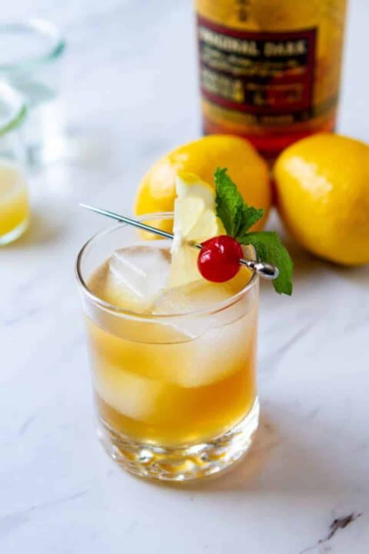 Rum Sour rum cocktail in a glass cup with ice.
