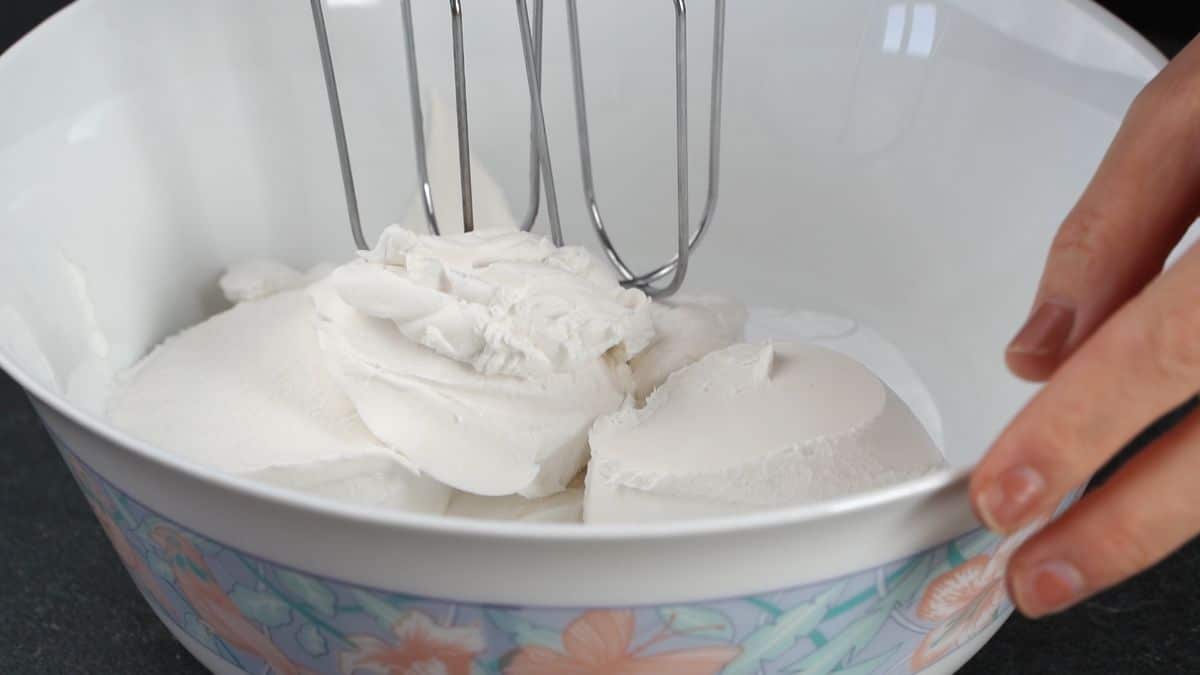 whisk in bowl with cream cheese