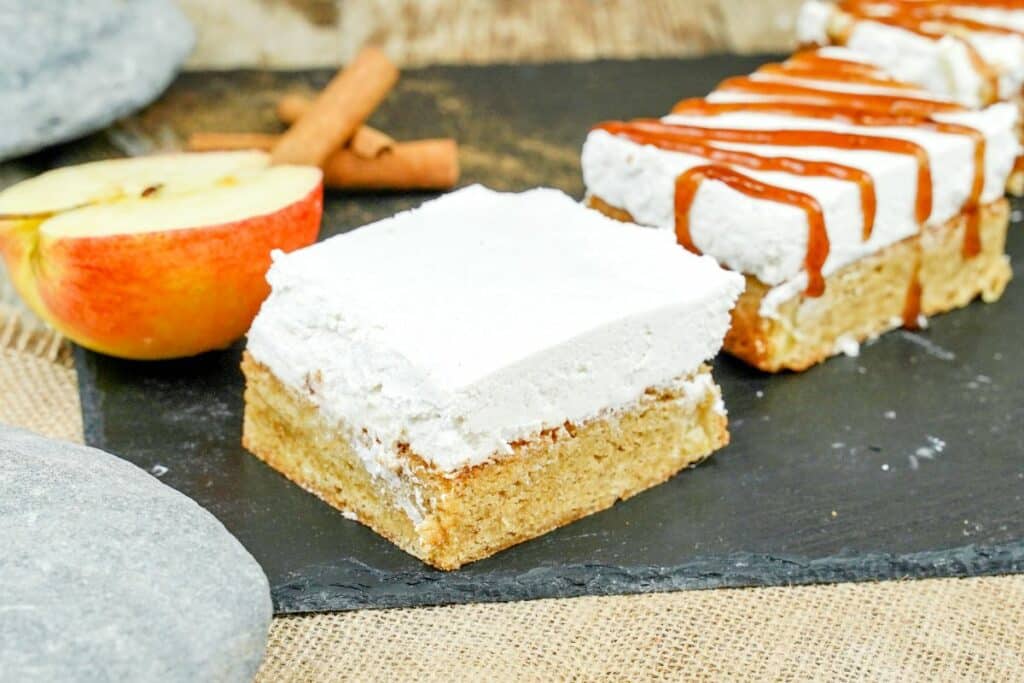 blondie with cheesecake topping on slate by iced blondies