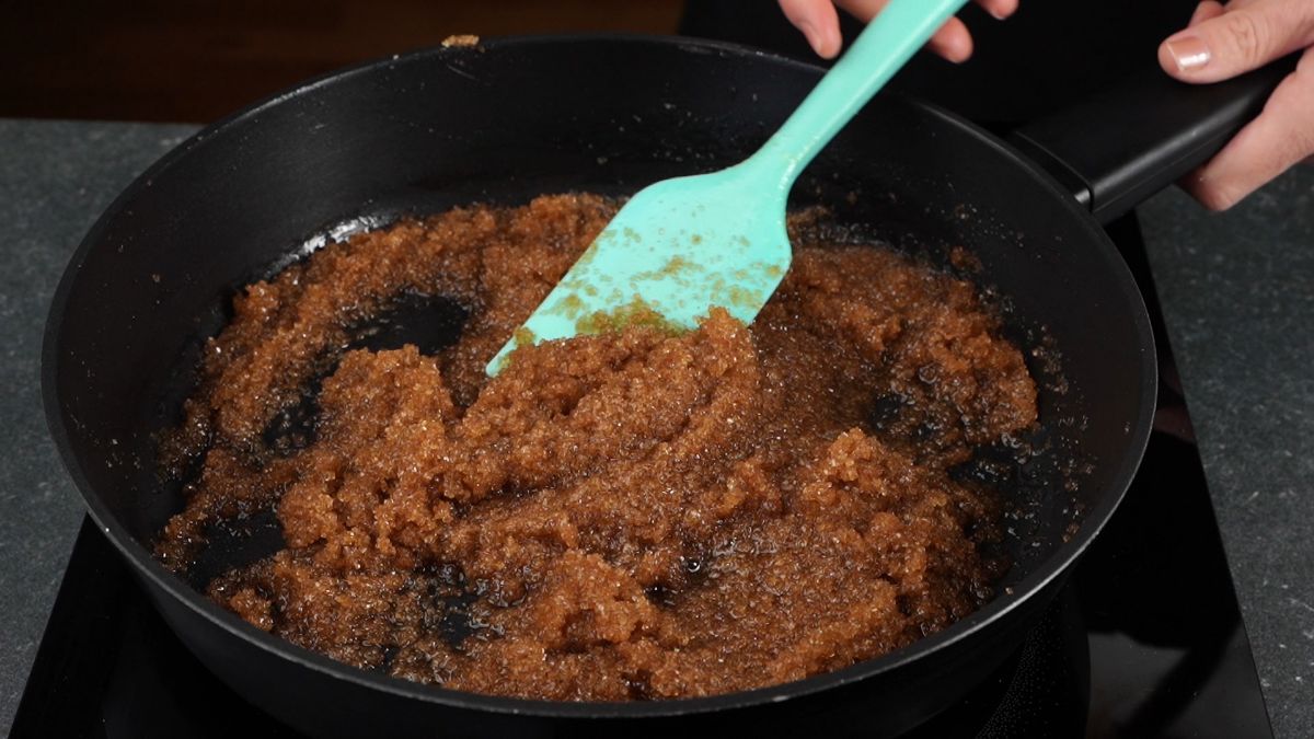 brown butter being stirred with sugar in cast iron skillet