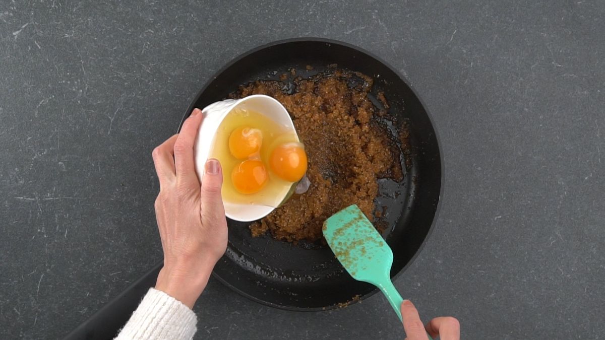 eggs being added to brown butter in skillet