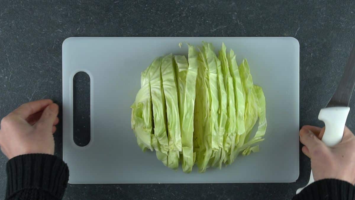 sliced cabbage on white cutting board