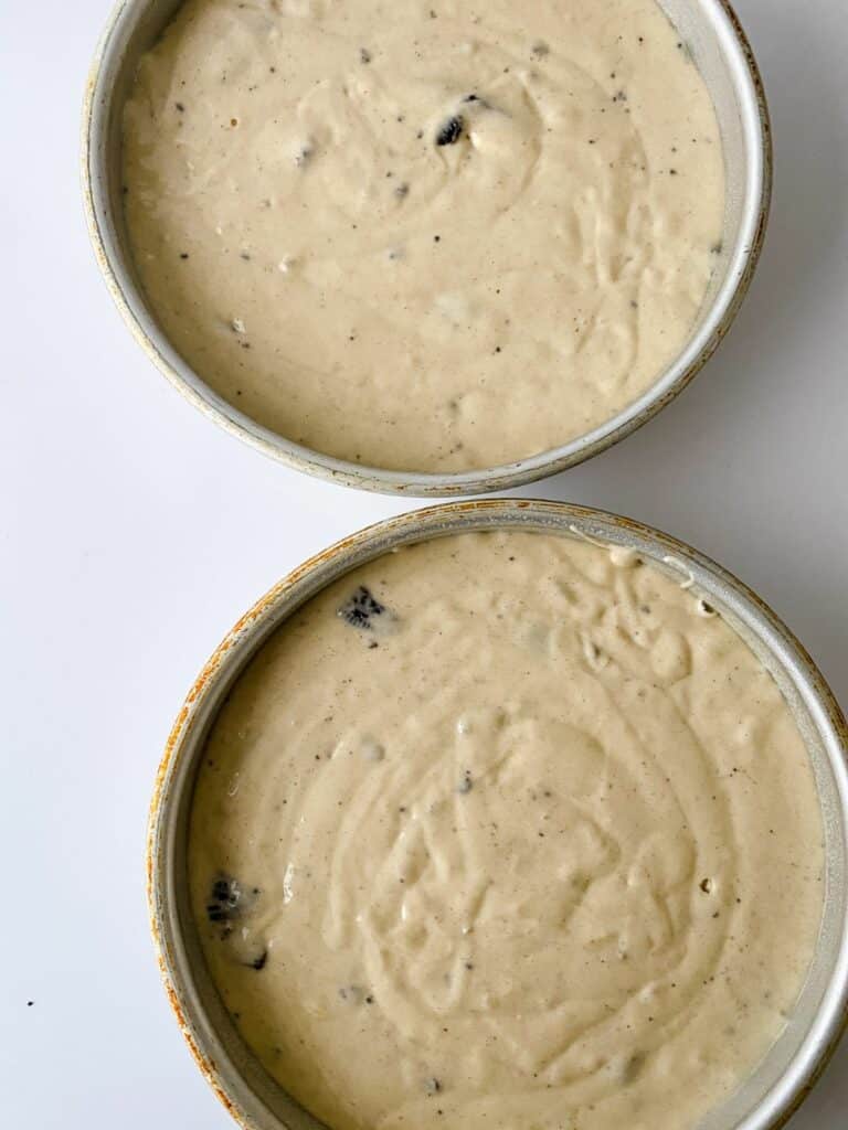 two unbaked cakes in round cake pans