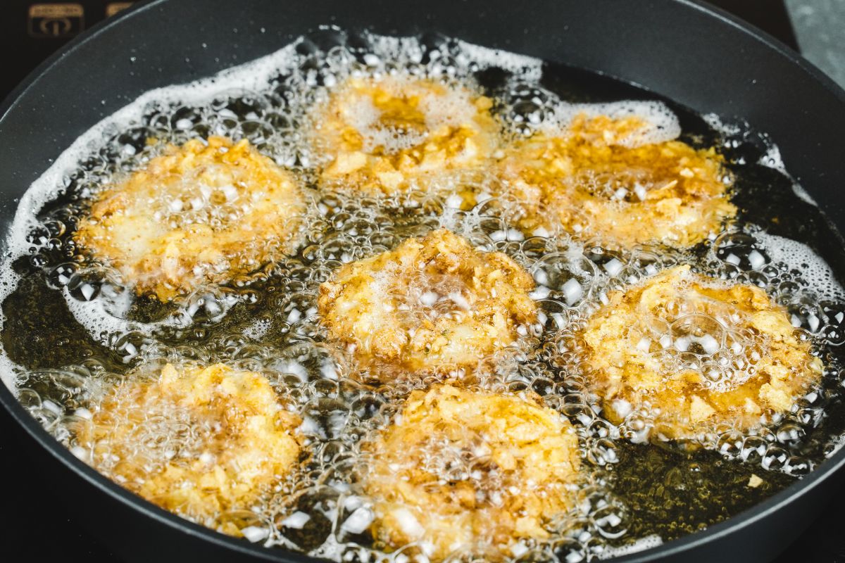 chicken rings frying in skillet of oil